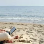 Available developer from India sitting on a beach