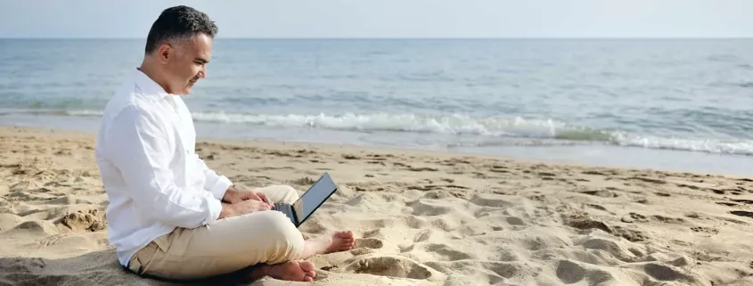 Available developer from India sitting on a beach